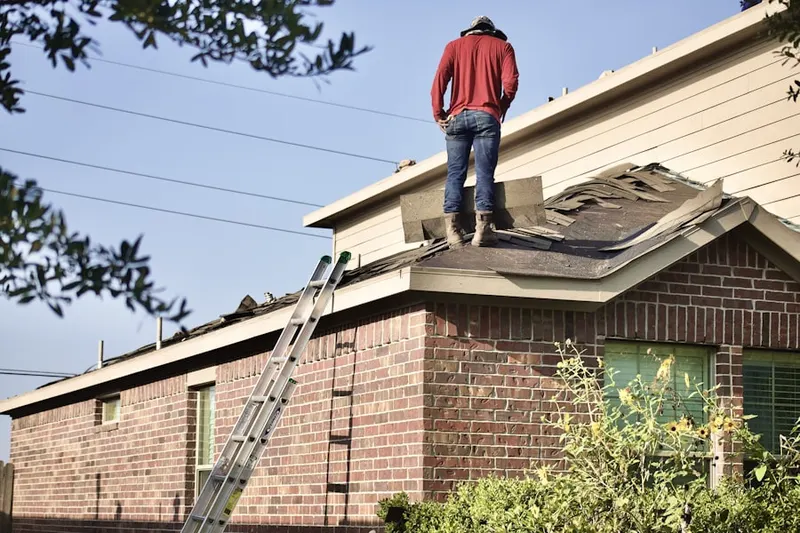Professional roofer working on a residential roof in Riverview Park